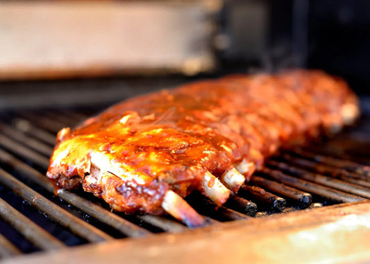 Ribs cooking on a grill.